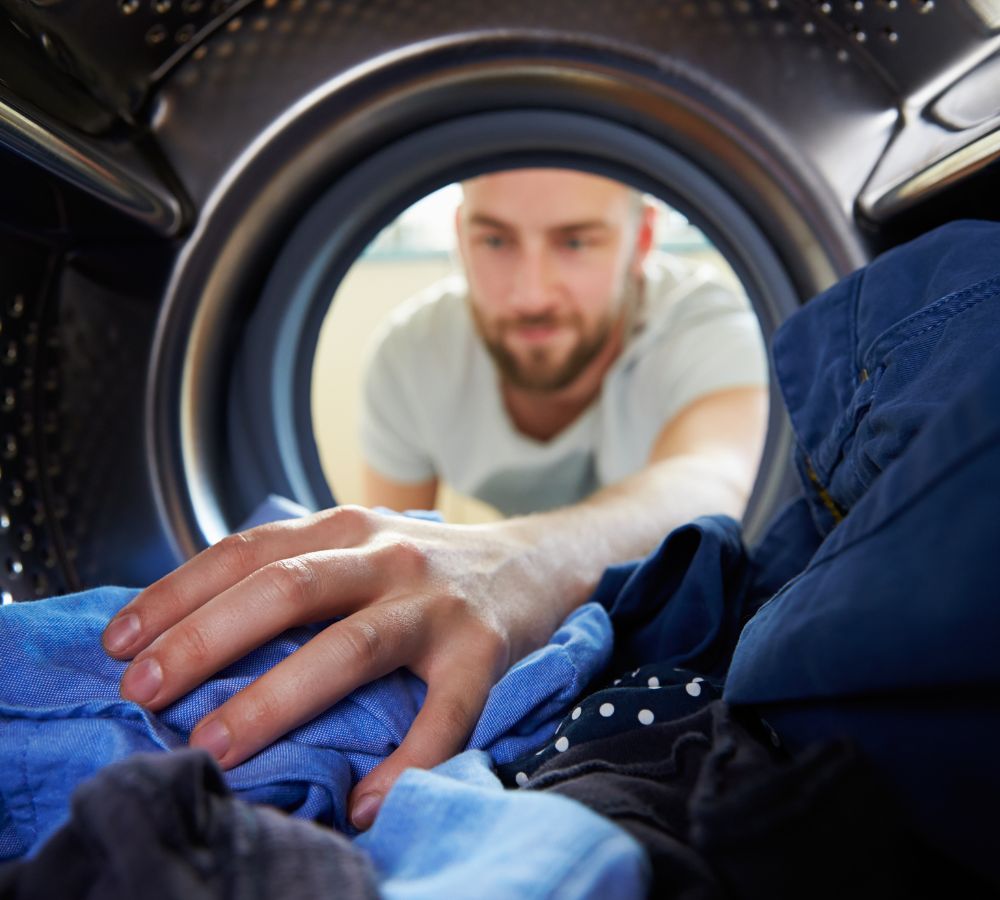 man doing laundry man doing laundry